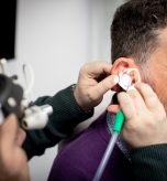 Audiologist performing professional microsuction ear wax removal at Kensington Hearing London.
