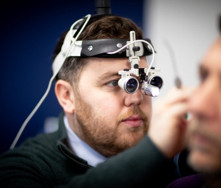 Audiologist performing safe professional ear wax removal at Kensington Hearing London